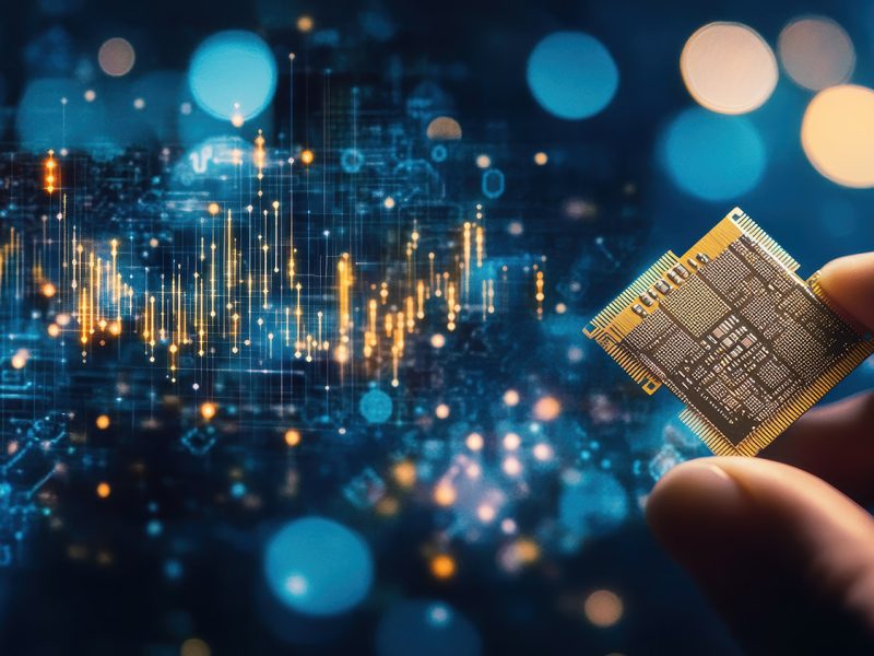 A photography, Close-up of a hand holding a gold and silver computer chip against a blurred blue background filled with bokeh effects. Overlaying the scene is a digital graph with upward trends, suggesting data analysis or technology. The mood is futuristic, highlighting innovation and captured with a Canon EOS-1D X Mark III, 70mm lens, f/2.2. --ar 16:9 --stylize 50 --v 6.1 Job ID: 432d5499-6707-43ef-8252-27eb4dac054d